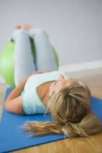 woman lying on floor doing exercise